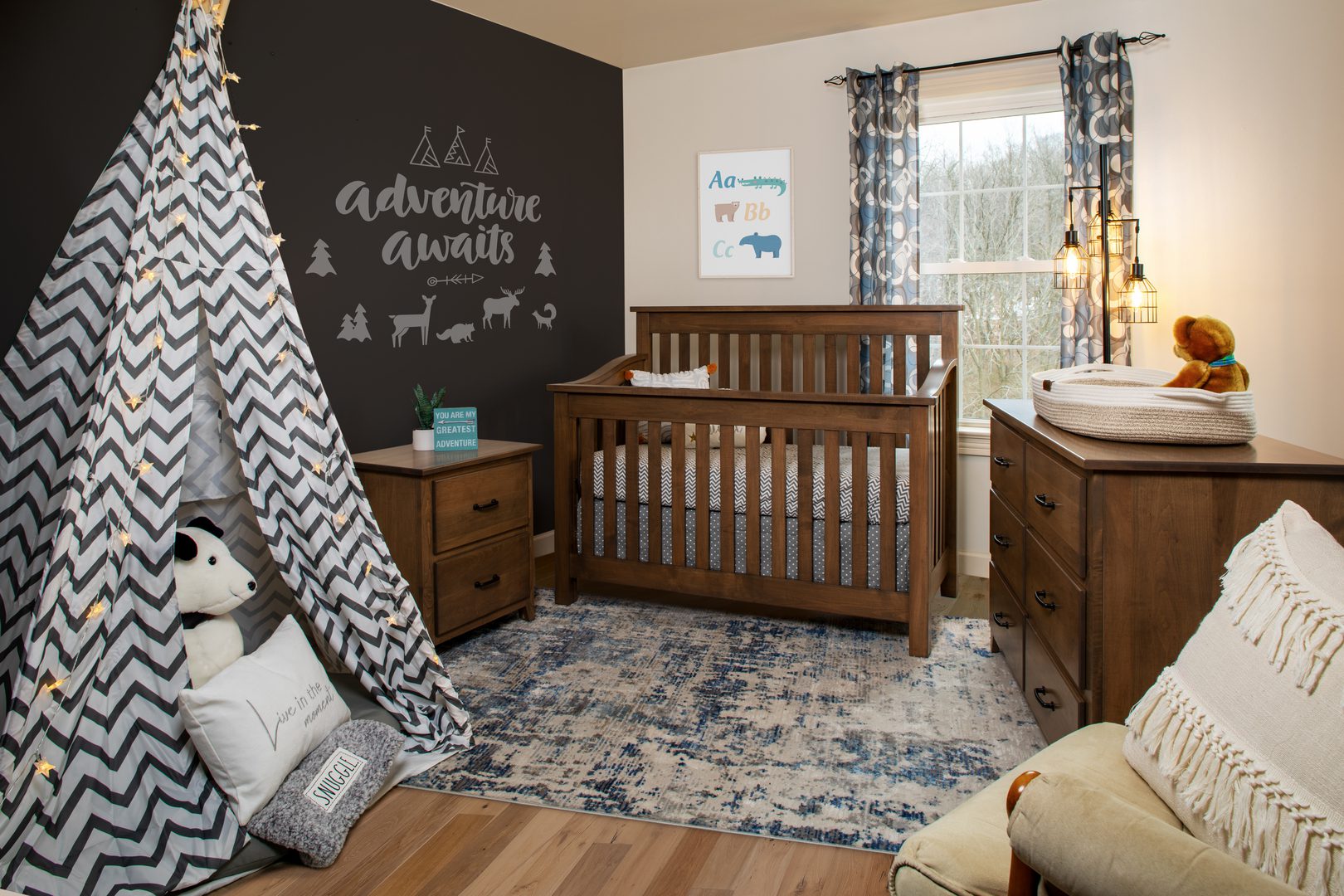 A cozy nursery with a wooden crib and patterned rug.