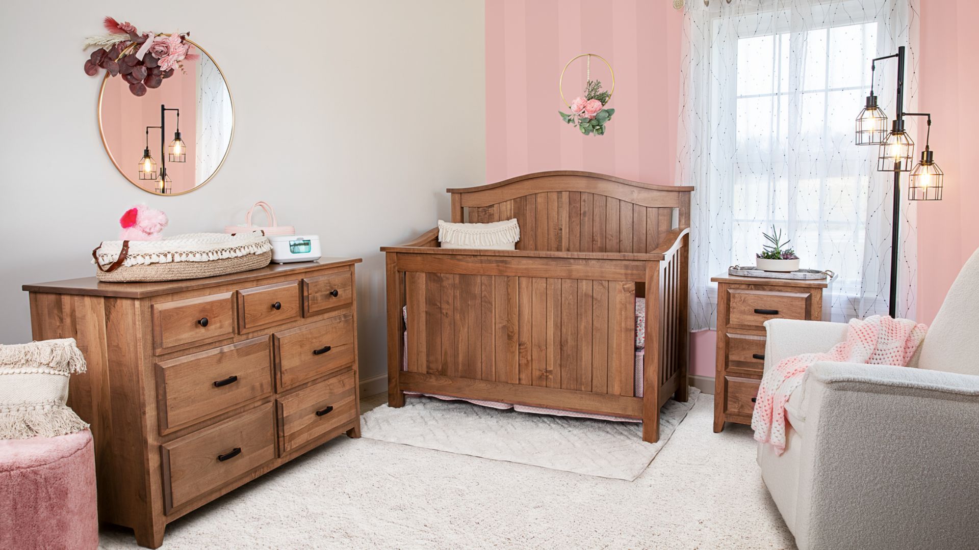 Wooden baby crib and dresser in a cozy nursery.
