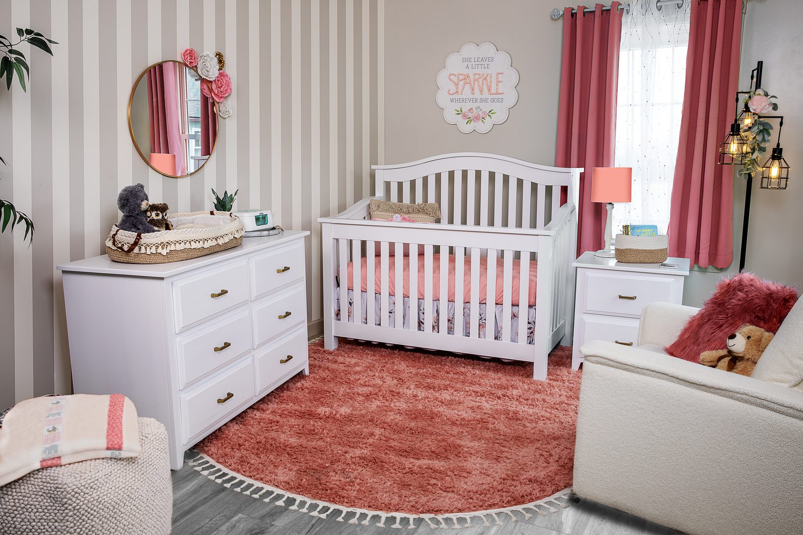 A cozy baby nursery with a white crib and pink accents.
