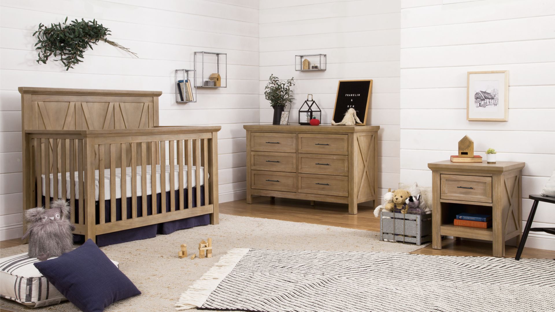 A cozy nursery with a wooden crib and dresser on a light rug.